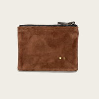 Brown suede pouch with gold hardware on a beige background