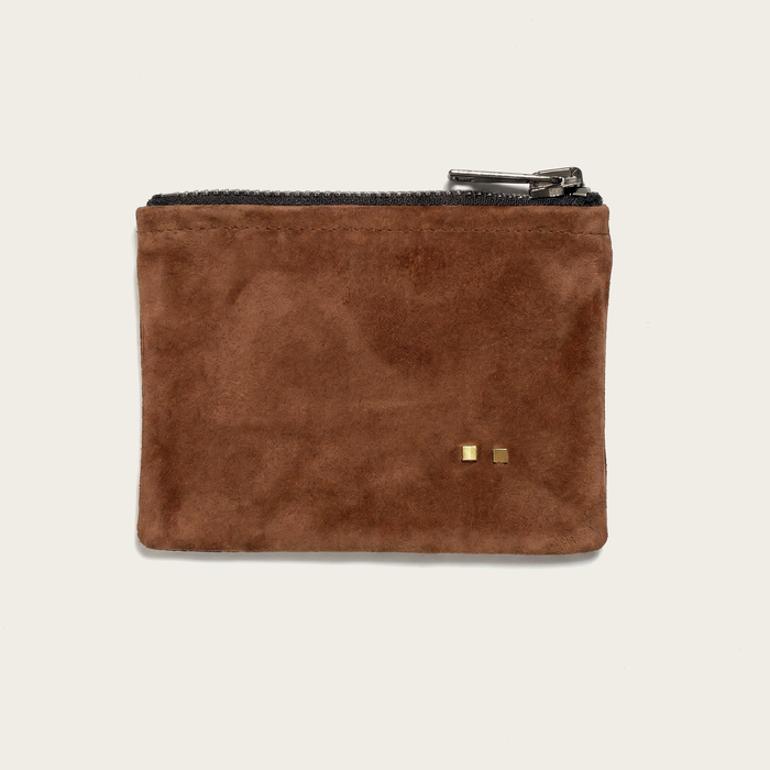 Brown suede pouch with gold hardware on a beige background