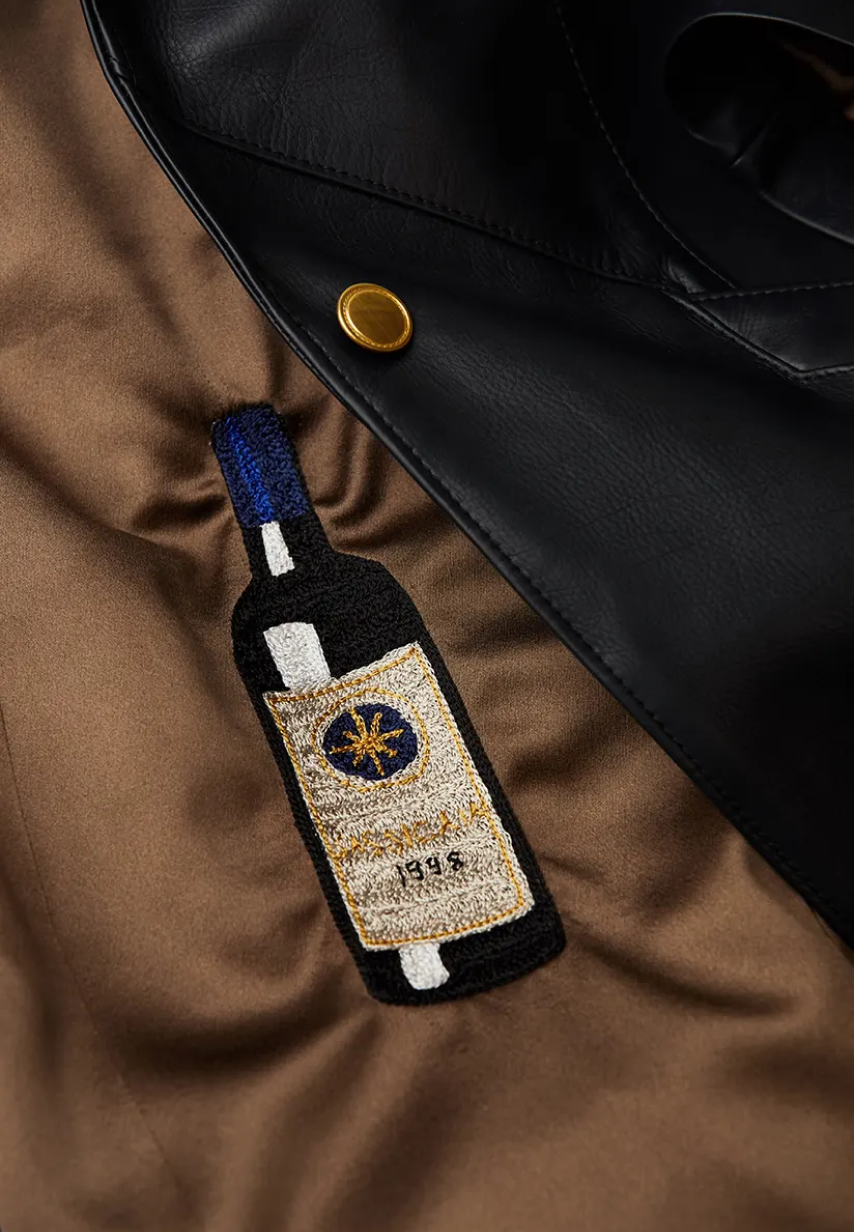 Example of multicolored Wine Bottle embroidery on a Savas jacket lining.