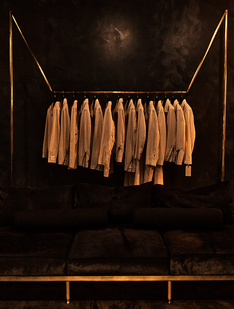 Image of several canvas mockups of jackets displayed on a rack.