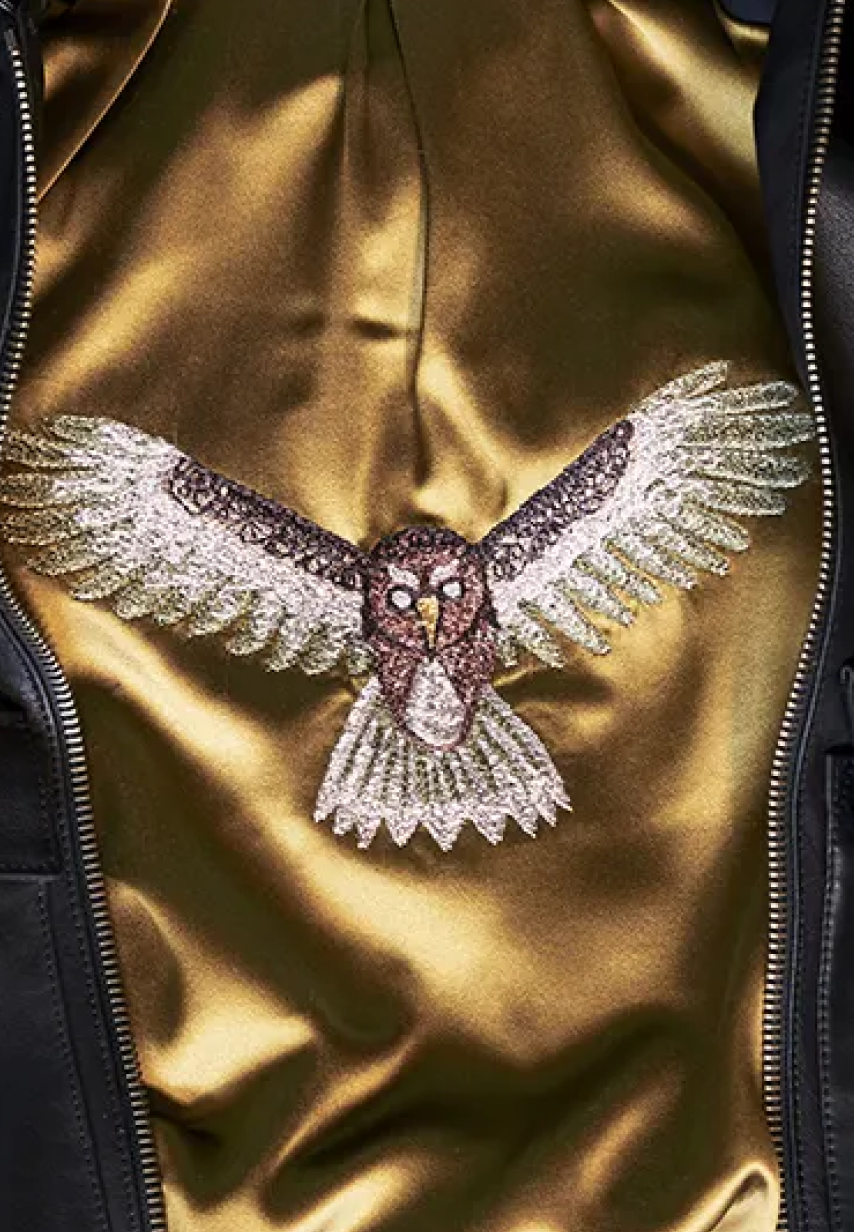 Example of multicolored flying owl embroidery on a Savas jacket lining.